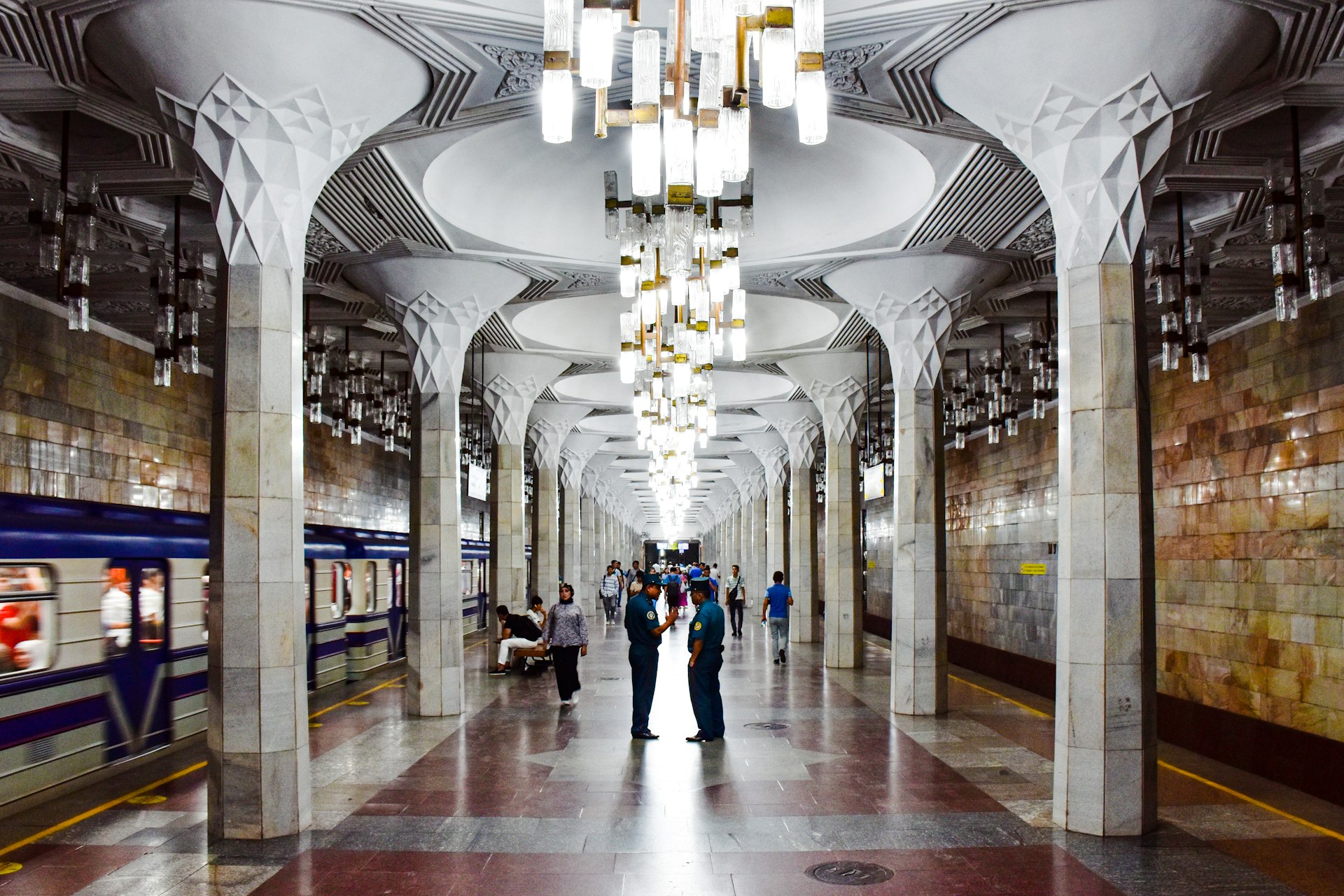 a subway station with people waiting for a train